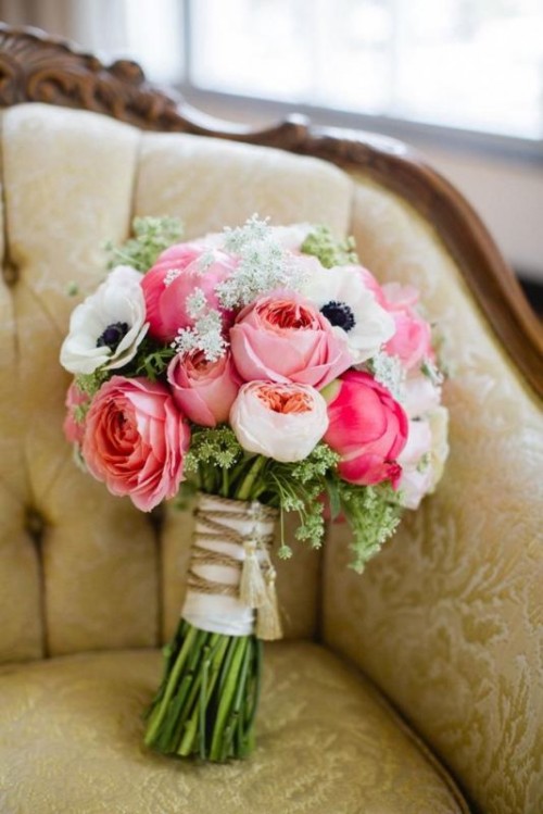 a pink wedding bouquet of roses, white anemones and some fillers for a spring or summer wedding