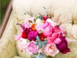 a pink wedding bouquet with fuchsia, hot pink, blush and orange blooms, some greenery is a cool idea for a bright wedding