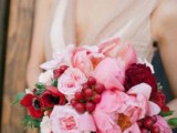 a burgundy and pink wedding bouquet with peonies, anemones, roses and berries for a red and pink wedding