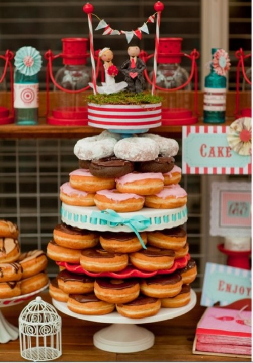 a stand with glazed donuts isn't only a budget-friendly but also a trendy idea today - who needs a cake when we can have donuts