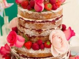 a naked wedding cake decorated with berries and fresh roses is a very romantic idea for a wedding