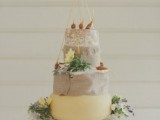 a cheese wheel cake decorated with onions and fresh blooms is a cool substitute for those who don’t like sweets