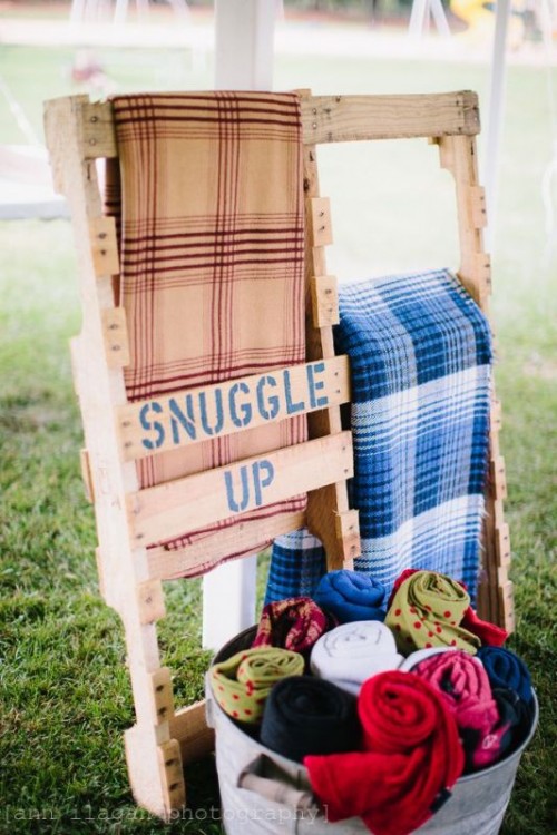 a pallet stand for blankets to keep your guests warm and comfortable during a chilly outdoor ceremony or reception