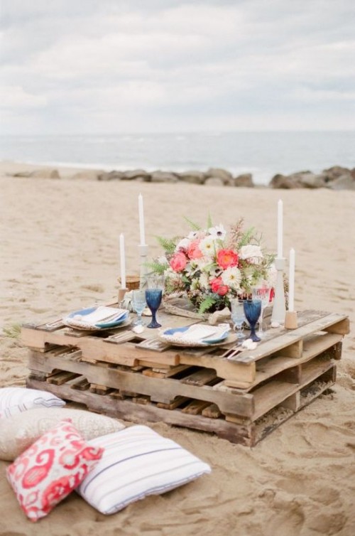 a pallet table may be placed on the beach for your wedding picnic, it's a simple idea