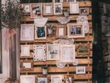 a pallet wedding backdrop with a gallery wall of photos, paintings and other meaningful stuff and lanterns