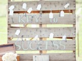 a pallet wedding sign with vintage keys and tags as escort cards is a creative vintage meets rustic idea