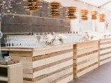 a large wedding drink station fully built of pallet wood is a cool recycling idea for a rustic wedding