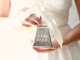 a tin box with a large creamy bow on top is a whimsical idea for carrying wedding rings