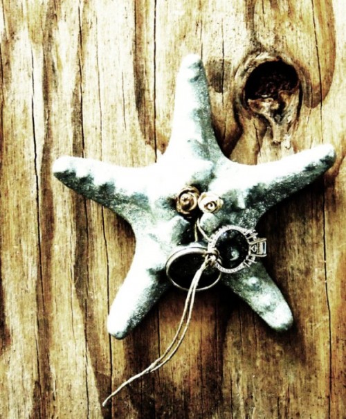 a star fish with ring is a cool idea for a beach or coastal wedding