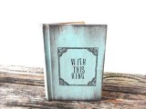 a blue vintage book with wedding rings inside is a fun idea for a book-loving wedding