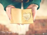 a small heart cut jornal with your favorite quotes or your pre-wedding diary is a cool ring pillow alternative
