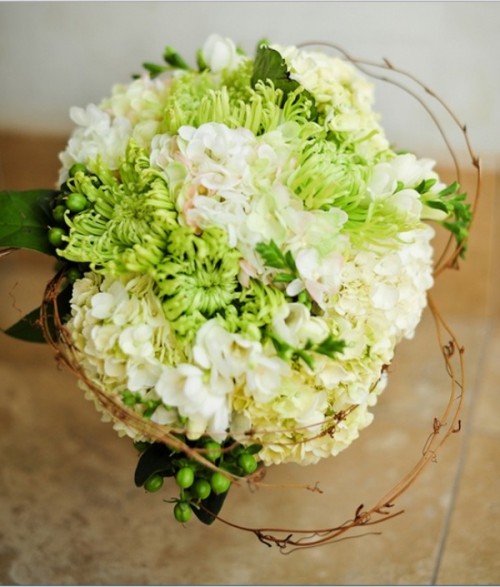 a bold lime green and white bouquet with berries and twigs is a creative idea for a spring or summer wedding with a touch of lime