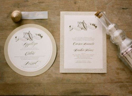 a beautiful ethereal neutral wedding beach invitation suite with seashell prints is very chic and very romantic