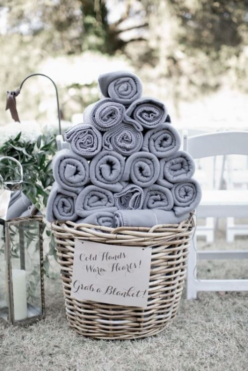 a basket with grey towels is a nice idea for offering towels to your wedding guests