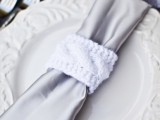a light grey napkin with a knit napkin ring is a stylish idea to rock and it looks very unusual