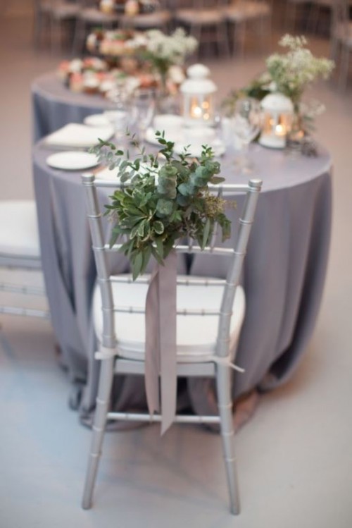 a grey tablecloth, greenery and a grey ribbon for an elegant and chic winter wedding tablescape