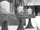 grey woven candleholders with grey berries and white candles inside are very stylish and cool