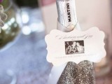 a grey glitter bottle with a photo is a very nice and cool winter wedding favor to rock