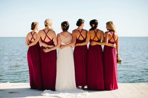 fuchsia maxi bridesmaid dresses with criss cross backs are amazing for a bright and cool summer or fall wedding