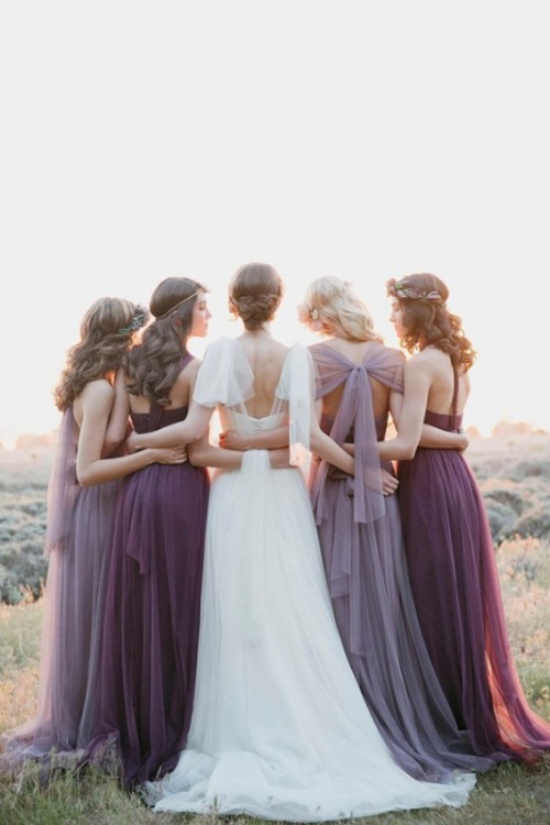 airy lilac and purple maxi bridesmaid dresses with pleated skirts and mismatching backs and necklines are very cool