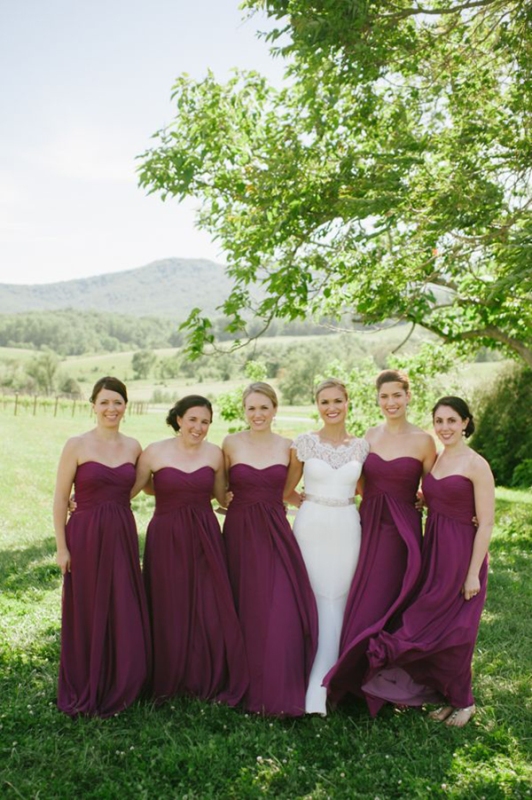 Strapless purple maxi bridesmaid dresses with draped bodices and skirts are great for a bold fall wedding