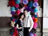 a colorful paper fan and pompom wedding backdrop is a great idea for a bright and cool wedding, it can be easily DIYed