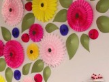 a colorful wedding backdrop composed of pink, yellow, fuchsia paper blooms and leaves is a great idea for a relaxed wedding, for the reception or dessert table
