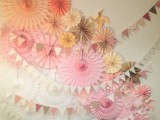 a beautiful and easy colored paper fan wedding backdrop with garlands is a lovely idea that can be DIYed and looks nice