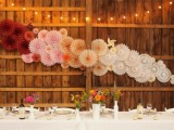 a pretty and cool ombre wedding backdrop made of paper fans is a lovely idea for a wedding, it works for the ceremony, reception and not only