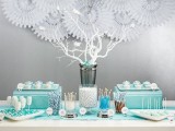 a backdrop of white paper fans is a lovely idea for a wedding, for your reception or a wedding dessert table, for example