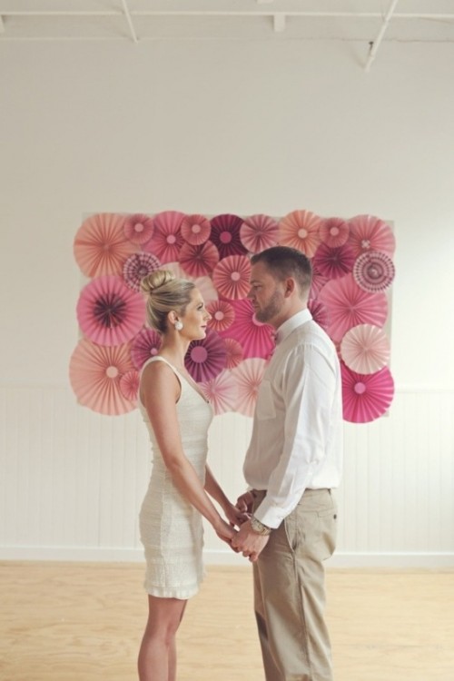 a blush, pink and mauve paper fan wedding backdrop is a stylish idea for a modern bright wedding, it won't break the bank