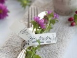 wedding cutlery with blooms secured with note paper is a nice idea for a music-loving wedding