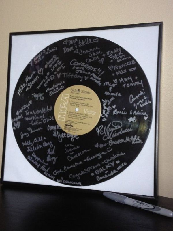 An oversized vinyl with signatures from your guests is a simple and cool guest book
