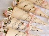 cones of note paper with pink blooms can be used throughout the venue to decorate it in various ways