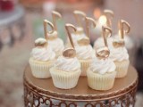 cupcakes topped with large edible gold notes are amazing for a music-loving wedding