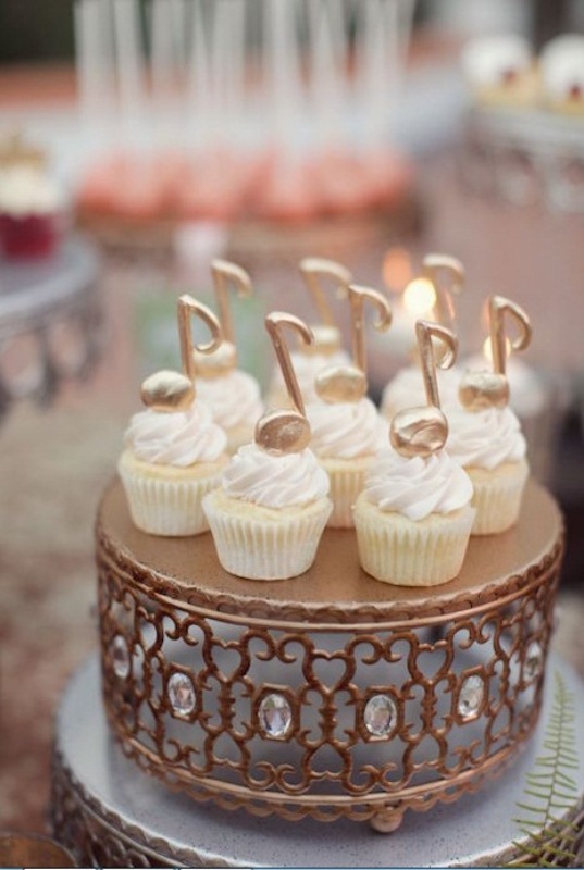 Cupcakes topped with large edible gold notes are amazing for a music loving wedding