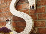 an oversized letter wrapped with note paper is a cool decoration for the venue and can be DIYed by you yourself