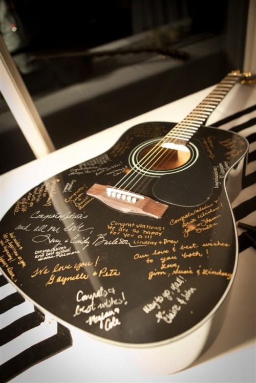 a guitar can be a nice idea of a wedding guest book, you can hang it on the wall for decor after the wedding