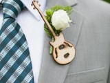 a fun boutonniere with a burnt out guitar and a single white bloom for accessorizing the groom’s suit