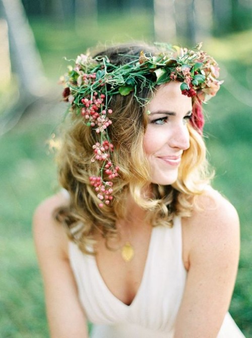 a lovely bright boho floral crown with greenery, red blooms and red berries hanging down is a cool and chic idea for a boho bride