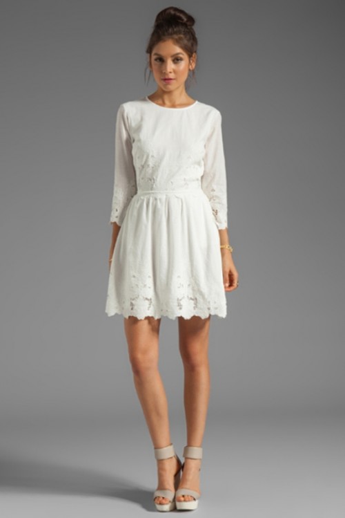 a simple white over the knee dress with a high neckline and short sleeves plus a lace edge is a chic idea