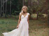 a lace A-line boho elopement wedding dress with cap sleeves, a deep V-neckline and layered necklaces
