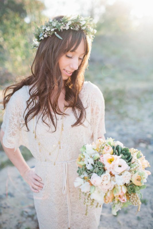 A vintage lace midi wedding dress with short sleeves, layered necklaces and a floral crown