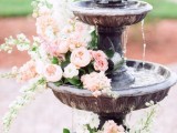 a vintage fountain with pink blooms on each tier is a lovely idea for a garden wedding, it’s beautiful and chic