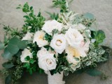a lush wedding bouquet with greenery and white blooms is a lovely idea for a spring or summer wedding in a garden