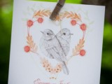 a wedding invitation with birds painted and some blooms is a pretty and romantic idea for a spring or summer wedding