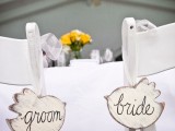 love bird-shaped wooden plaques instead of traditional chair signs are a cool and simple DIY idea to try