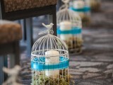 cages with moss and candles and little love birds on top are great to line the aisle and make the space cooler and brighter