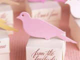 favor boxes with pink love birds on top will be a nice solution for a cute and informal wedding