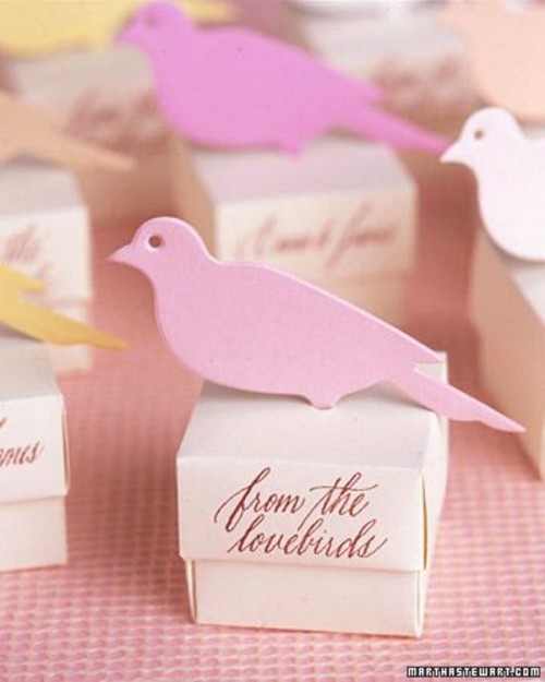 favor boxes with pink love birds on top will be a nice solution for a cute and informal wedding
